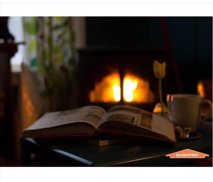 Coffee and book by fireplace.