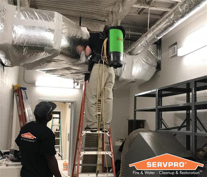 SERVPRO employees cleaning air ducts.